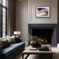 Riof Beach landscape print in a black frame above a charcoal fireplace in a contemporary living room with a blue sofa.